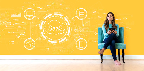 SaaS - software as a service concept with young woman holding a tablet computer
