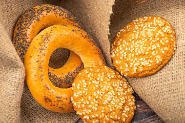 Bagels and cookies on a background of rough homespun fabric. Close up.