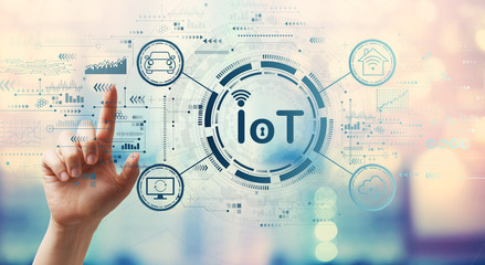 IoT theme with hand pressing a button on a technology screen