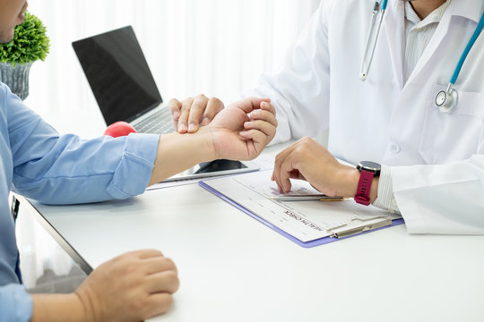Male doctor are examining the patient's wrist pain.