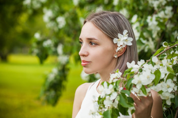 Fototapeta premium Portrait of young natural woman in spring garden
