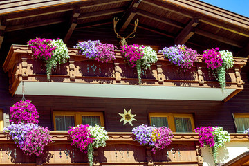 Fototapeta na wymiar Beautiful house with flowers in the mountains on a summer day