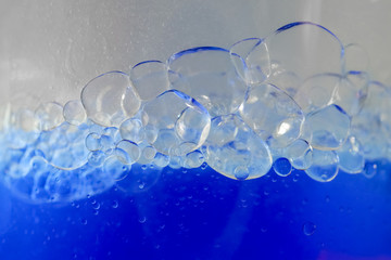 blue bubbles of micellar water macro as background 