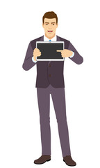 Smiling Businessman pointing at tablet computer. Full length portrait of Businessman in a flat style.