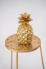 golden pineapple on a chair. Scenery