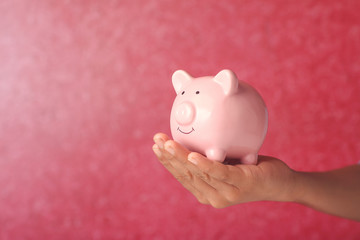 Boy holding piggy bank for savings