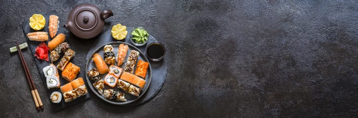 Foto op Plexiglas sushi rolls with rice and fish, soy sauce on a dark stone background © Наталья Майорова