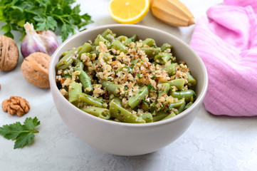 Salad with green beans and spicy walnut sauce in a bowl. Vegetarian, vegan menu