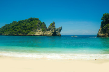 Idyllic tourist destination in Asia - beautiful scenic view of rock cliff in the sea at the exotic and relaxing Atuh beach tropical paradise at unique Summer holidays travel