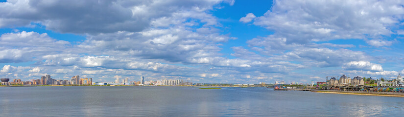 beautiful panoramic view with modern high houses and city parks on the river