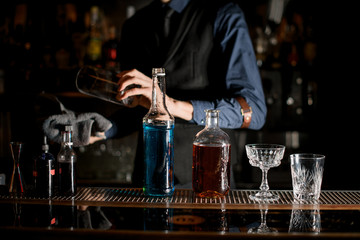 Bottles and glasses stand at the bar.