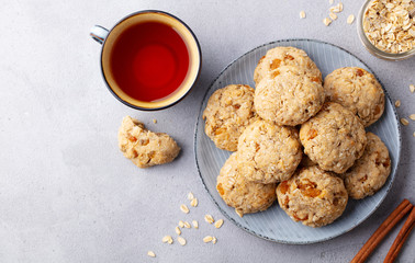 Healthy vegan oat cookies with cup of tea. Grey background. Top view.