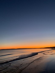 Fototapeta na wymiar sunset on the beech with waves