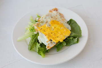 fried egg with green lettuce for keto diet and nutrition