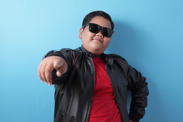 Obraz premium Fat rich Asian boy smiling at camera with proud