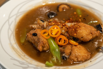 Noodles topped with Soy Sauce and Fish Sea Bass.