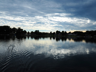 Lake with blue skies and clouds reflected