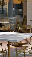  sparrow bird on marmor table with golden chairs in Singapore