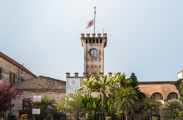 Clock tower with the Catholic flag on the territory of the catholic Christian Transfiguration Church located on Mount Tavor near Nazareth in Israel