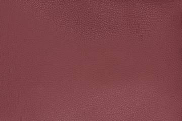 Old red smooth natural leather in medium grain textured background