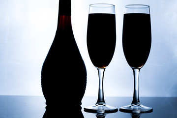glass of wine and bottle on black background