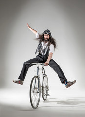 Portrait of a skinny nerd riding a bike