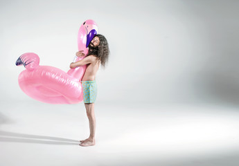 Skinny man holding a rubber flamingo - isolated