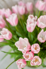 Decor and a vase with pink tulips on a table
