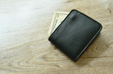 ten US dollar banknote from wallet on table