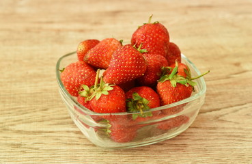 fresh strawberry in glass bowl on table