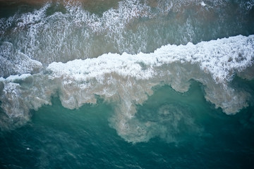 Obraz na płótnie Canvas Aerial View of Waves and Azure beach with rocks. Kerala, India.