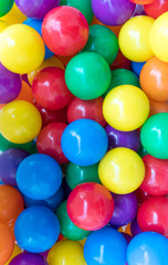 Many colorful plastic balls in a playground.