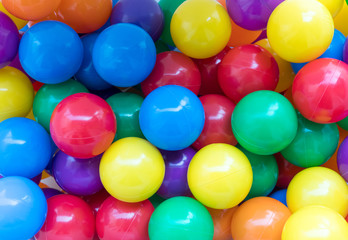 Many colorful plastic balls in a playground.