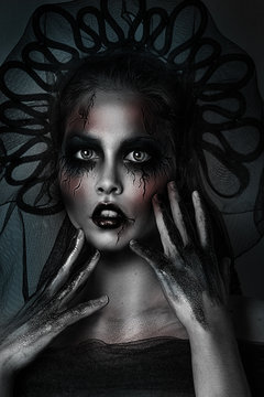 Close up portrait of sexy dark princess with Halloween professional makeup. Black and white photography