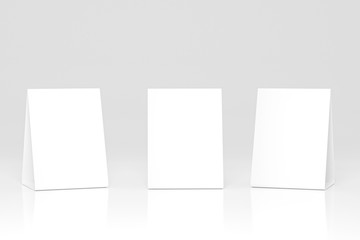 Promotional table talker isolated on white background, mockup template paper tri-fold vertical triangle cards with reflections. white sheets front & left and right view. 3d render