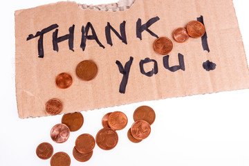 Cent coins and thank you written on the cardboard