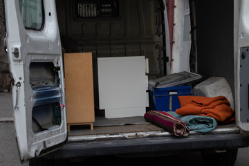 Opened truck door with things. Moving to another apartment concept