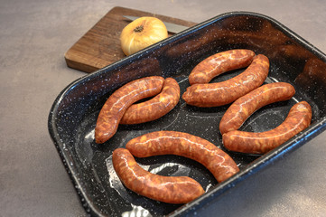 Home made sausages in a baking tray