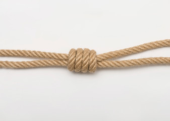 Triple fisherman knot. Isolated image of tangled ropes on white background.