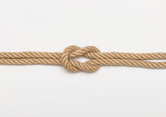Reef knot. Isolated image of tangled ropes on white background.