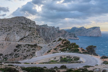 Cloudy landscape of the winding road towards the lighthouse of Cabo de Formentor, on the coast of Pollensa, Mallorca