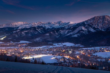 Amazing illuminated Zakopane city after dusk in winter, aerial view