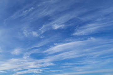 Bright beautiful blue sky with soft clouds for background or texture