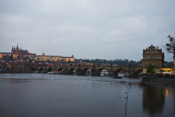 Evening walk sightseeing traveling fall to Prague, Czech Republic. Charles bridge and promenade.