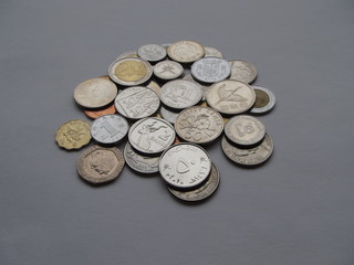 Coins of different countries on a gray background. 