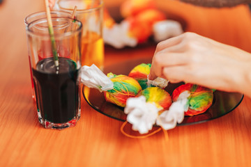 Easter eggs on table, Woman paint in wih the help of brush.