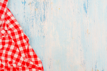Red checkered towel on the kitchen table. Wooden blue kitchen table.
