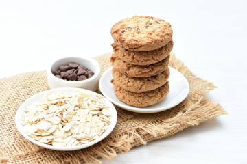 Oatmeal cookies and chocolate chips on cloth background
