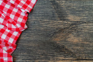 Red checkered towel on the kitchen table. Wooden kitchen table.