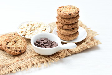 Oatmeal cookies and chocolate chips on cloth background